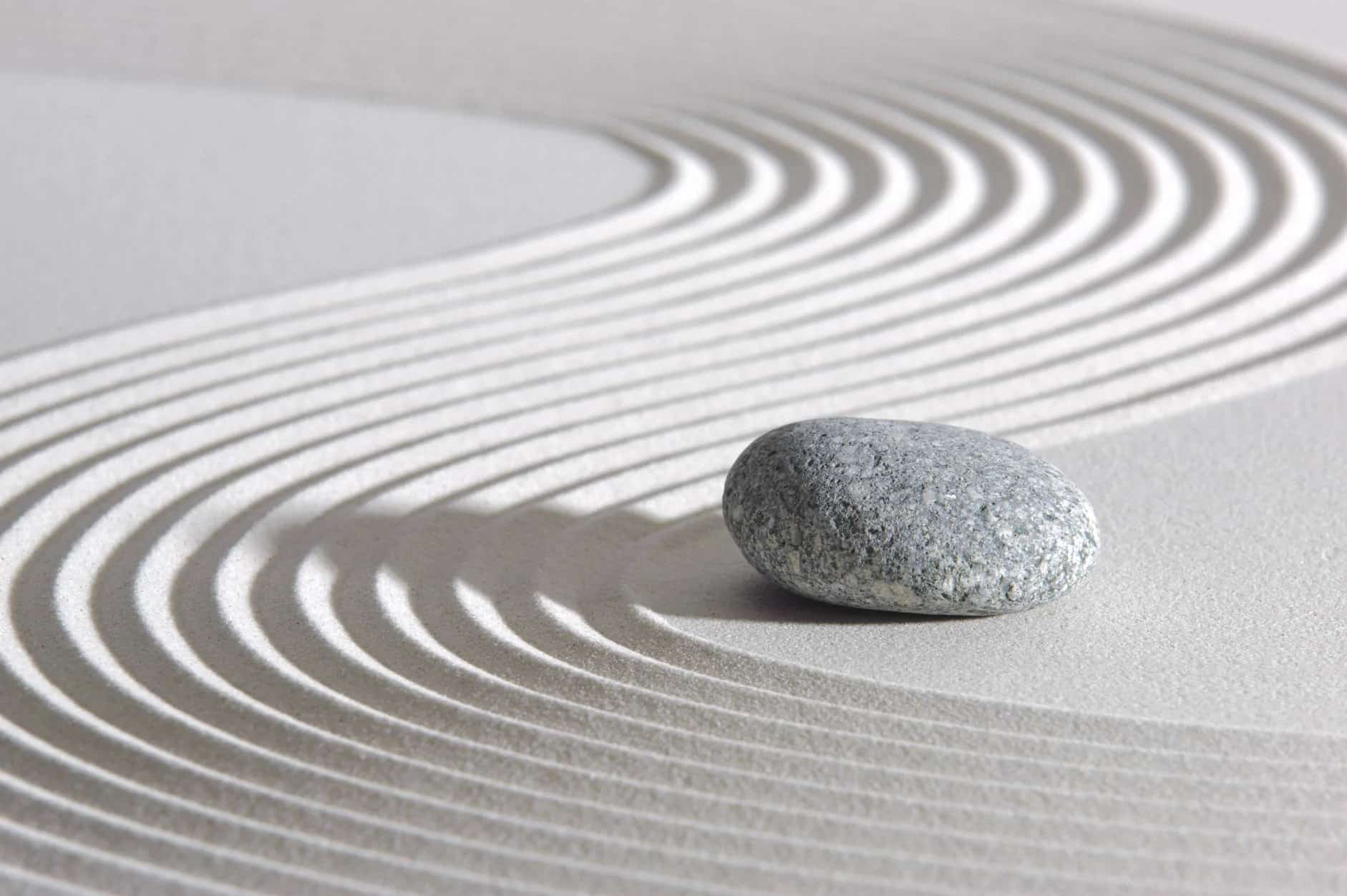 Japanese garden with gray rock and sand waves.