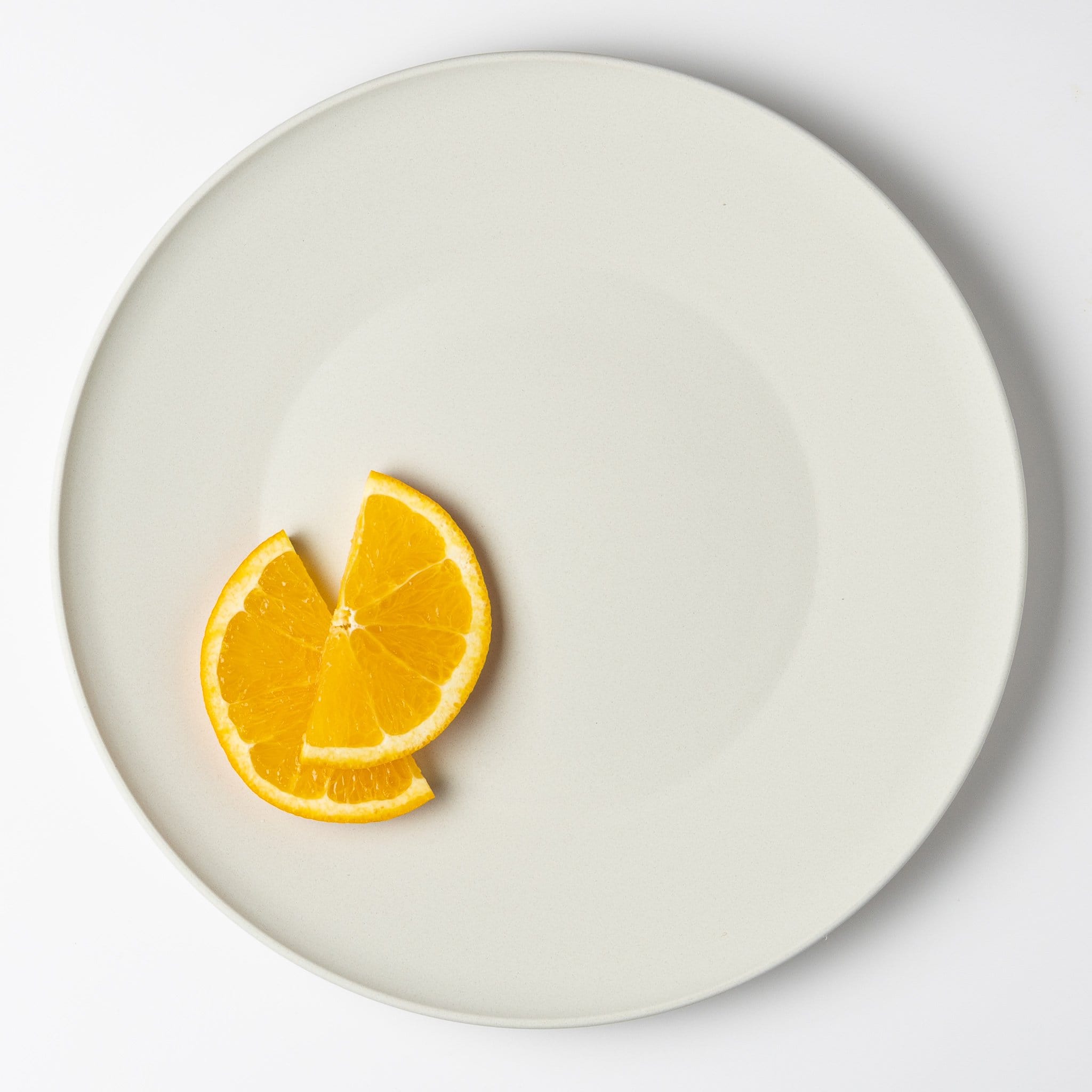Orange slices on off-white plate